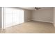 Light-filled living room with sliding glass door and stylish ceiling fan at 5208 W Earll Dr, Phoenix, AZ 85031