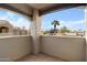 View from the balcony overlooking a residential community with palm trees, tile flooring, and partial walls at 5335 E Shea Blvd # 2022, Scottsdale, AZ 85254