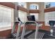 Community fitness center with treadmills and stationary bikes overlooking the pool at 5335 E Shea Blvd # 2022, Scottsdale, AZ 85254