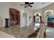 Kitchen bar with granite countertop, wine storage and natural light from an arched window at 5335 E Shea Blvd # 2022, Scottsdale, AZ 85254