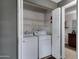 Laundry closet featuring a side-by-side washer and dryer set, and shelving, as well as a view of an adjacent bathroom at 5335 E Shea Blvd # 2022, Scottsdale, AZ 85254