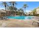 Inviting community pool surrounded by lounge chairs, palm trees, and multiple residential buildings in the background at 5335 E Shea Blvd # 2022, Scottsdale, AZ 85254