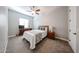 This bedroom features carpet, a ceiling fan, a window and standard bedroom furniture at 5621 N 189Th Dr, Litchfield Park, AZ 85340