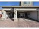 This garage features two garage doors with one having a storage area and a brick driveway at 5621 N 189Th Dr, Litchfield Park, AZ 85340