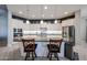 Bright kitchen with an island and white cabinetry, stainless steel appliances, and pendant lighting at 5621 N 189Th Dr, Litchfield Park, AZ 85340