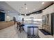 A kitchen boasts an island with granite counters, stainless appliances, and white cabinets against a navy accent wall at 5621 N 189Th Dr, Litchfield Park, AZ 85340