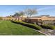 Serene backyard featuring a well-manicured lawn and decorative brickwork, enhancing the property's appeal at 5621 N 189Th Dr, Litchfield Park, AZ 85340