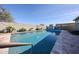 Backyard swimming pool with stone decking and privacy wall at 5621 N 189Th Dr, Litchfield Park, AZ 85340