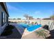 Backyard swimming pool and yard featuring drought-resistant landscaping at 5621 N 189Th Dr, Litchfield Park, AZ 85340