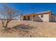 Home featuring a covered patio with desert landscape, neutral stucco with red trim, and mountain views at 6431 N 418Th Ave, Tonopah, AZ 85354