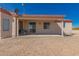 Home featuring a covered patio with desert landscape, neutral stucco with red trim at 6431 N 418Th Ave, Tonopah, AZ 85354