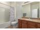 Bathroom featuring a single sink vanity with granite counters, toilet, and tub/shower combo at 6431 N 418Th Ave, Tonopah, AZ 85354