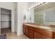 Bathroom featuring a double sink vanity with granite counters and a glass-enclosed shower at 6431 N 418Th Ave, Tonopah, AZ 85354