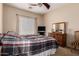 Bedroom showcasing a ceiling fan, flat screen TV, and a wooden dresser at 6431 N 418Th Ave, Tonopah, AZ 85354