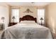 Cozy bedroom showcasing a decorative headboard and bedside tables with lamps at 6431 N 418Th Ave, Tonopah, AZ 85354