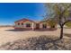 Charming single-story home with a desert landscape, neutral stucco, red trimmed roof, and a welcoming entrance at 6431 N 418Th Ave, Tonopah, AZ 85354