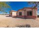 Home exterior featuring desert landscaping, neutral stucco with red trim and mountain views at 6431 N 418Th Ave, Tonopah, AZ 85354