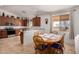 Open kitchen with modern appliances, a breakfast bar, and a view into the dining area at 6431 N 418Th Ave, Tonopah, AZ 85354