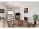 Bright living room featuring a comfortable seating area, tile floors, and access to the outdoor space at 6431 N 418Th Ave, Tonopah, AZ 85354