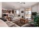 Inviting living room with neutral tones, cozy seating, and sliding glass doors leading to the outdoors at 6431 N 418Th Ave, Tonopah, AZ 85354