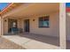 Covered patio with neutral tones offers a shaded outdoor space with bench seating at 6431 N 418Th Ave, Tonopah, AZ 85354