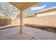 View of the backyard patio area with a concrete floor and brick walls at 6718 E Northridge St, Mesa, AZ 85215