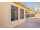 View of the exterior back of the home showing windows and a patio at 6718 E Northridge St, Mesa, AZ 85215