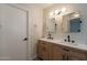 Bathroom featuring a wood vanity with double sinks and matte black hardware at 6718 E Northridge St, Mesa, AZ 85215