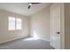 A cozy bedroom offers natural light with neutral walls and includes ceiling fan at 6718 E Northridge St, Mesa, AZ 85215