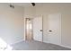 Bedroom featuring neutral walls, carpet floors, ceiling fan and access to another bedroom at 6718 E Northridge St, Mesa, AZ 85215