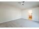 Spacious bedroom with plush carpet, neutral walls and archway to the ensuite bathroom at 6718 E Northridge St, Mesa, AZ 85215