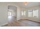 A bright dining room with wood floors with view to patio and living room at 6718 E Northridge St, Mesa, AZ 85215