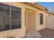 Front door of a house with secure screen door, windows, and desert landscaping at 6718 E Northridge St, Mesa, AZ 85215