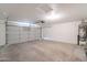 Spacious garage with concrete floors, overhead lighting, and a garage door opener at 6718 E Northridge St, Mesa, AZ 85215