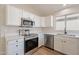 Beautiful kitchen with stainless steel appliances, white cabinets and countertops at 6718 E Northridge St, Mesa, AZ 85215