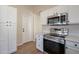 Bright kitchen features stainless steel appliances, white cabinetry and sleek countertops, creating a modern and inviting space at 6718 E Northridge St, Mesa, AZ 85215