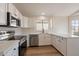 Modern kitchen featuring stainless steel appliances, white countertops, and ample cabinet space at 6718 E Northridge St, Mesa, AZ 85215