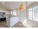 Bright, open-concept kitchen with stainless steel appliances, white cabinets and countertops, and modern lighting at 6718 E Northridge St, Mesa, AZ 85215