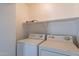 A laundry room with a washing machine and dryer on a shelf at 6718 E Northridge St, Mesa, AZ 85215