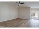 Living room featuring laminate floors, ceiling fan, and access to the backyard at 6718 E Northridge St, Mesa, AZ 85215