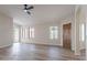 Inviting living room with laminate floors, ceiling fan, and natural light from the windows at 6718 E Northridge St, Mesa, AZ 85215