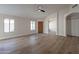 Bright and airy living room with laminate floors, ceiling fan, and a welcoming front door at 6718 E Northridge St, Mesa, AZ 85215