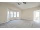 Spacious main bedroom with ceiling fan features natural light and neutral carpet at 6718 E Northridge St, Mesa, AZ 85215