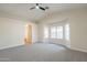 Spacious main bedroom with ceiling fan features natural light and neutral carpet at 6718 E Northridge St, Mesa, AZ 85215