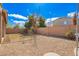 Wide backyard with gravel landscaping, privacy fence, and a view of surrounding greenery at 6812 S 45Th Ave, Laveen, AZ 85339