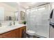 Bathroom featuring a stand-up shower with a glass enclosure, framed art, and ample lighting at 6812 S 45Th Ave, Laveen, AZ 85339