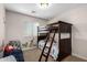 Bright bedroom featuring a charming bunk bed, a window with blinds, and playful animal wall decals at 6812 S 45Th Ave, Laveen, AZ 85339