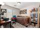 Cozy bedroom features functional desk space, natural light, neutral tones, and convenient shelving at 6812 S 45Th Ave, Laveen, AZ 85339