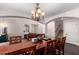 Formal dining room with a large table, chandelier, and views into the living room at 6812 S 45Th Ave, Laveen, AZ 85339