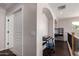 Upstairs hallway with dark wood floors, white walls, arched doorways and keyboard at 6812 S 45Th Ave, Laveen, AZ 85339